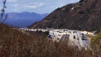 Time lapse traffic on a freeway cutting through a mountain pass. video