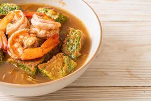 Sour soup made of Tamarind Paste with Shrimps and Vegetable Omelet photo