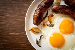 Homemade double fried egg with fried pork sausage - for breakfast photo