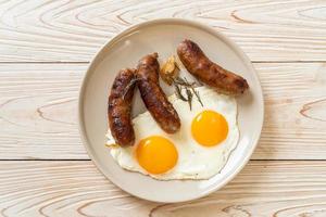 Homemade double fried egg with fried pork sausage - for breakfast photo