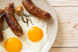 Homemade double fried egg with fried pork sausage - for breakfast photo