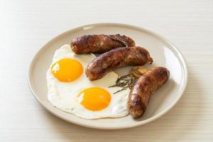 Homemade double fried egg with fried pork sausage - for breakfast photo