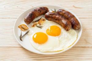 Homemade double fried egg with fried pork sausage - for breakfast photo