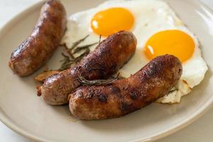 Homemade double fried egg with fried pork sausage - for breakfast photo