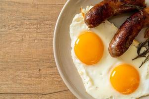 Homemade double fried egg with fried pork sausage - for breakfast photo