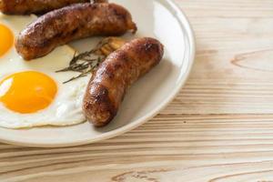 Homemade double fried egg with fried pork sausage - for breakfast photo