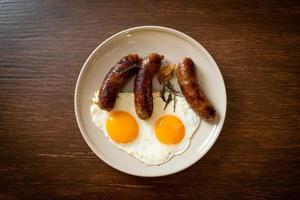 Homemade double fried egg with fried pork sausage - for breakfast photo