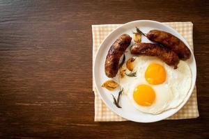 Homemade double fried egg with fried pork sausage - for breakfast photo