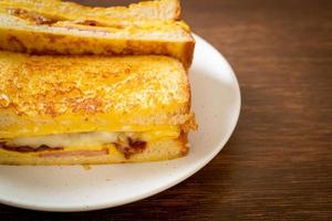 Homemade French toast with ham, bacon, and cheese sandwich with egg photo