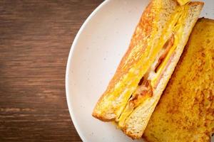 Homemade French toast with ham, bacon, and cheese sandwich with egg photo