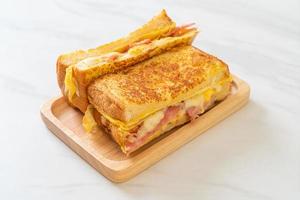 Homemade French toast with ham, bacon, and cheese sandwich with egg photo