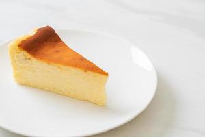 Homemade burn cheesecake on a white plate
