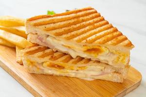 Ham and cheese sandwich with egg and fries