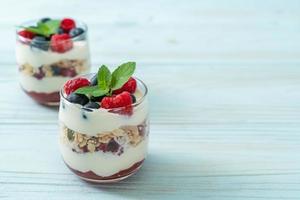 Homemade raspberry and blueberry with yogurt and granola - healthy food style photo