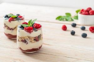 Homemade raspberry and blueberry with yogurt and granola - healthy food style photo