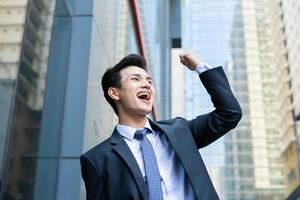 Portrait of young Asian businessman outside the office photo