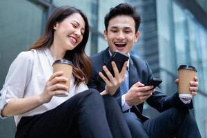 Two Asian business people are discussing work during recess photo