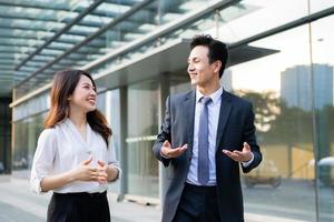 Two business people walking and talking together photo