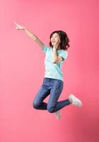 Cheerful young girl jumping up on the background