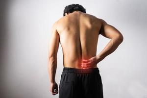 A portrait of a man touching a painful back photo