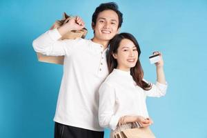 Happy young Asian couple happily going shopping photo