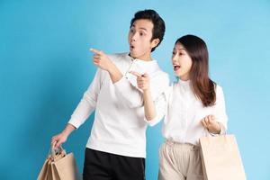 Happy young Asian couple happily going shopping photo