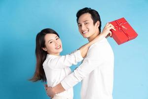 Asian boyfriend gives gifts to his girlfriend on Valentine's Day photo