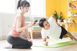 Your girlfriend is timing for her boyfriend to do plank at home photo