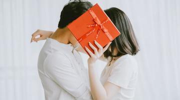 Asian boyfriend gives gifts to his girlfriend on Valentine's Day photo