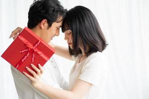 Asian boyfriend gives gifts to his girlfriend on Valentine's Day photo