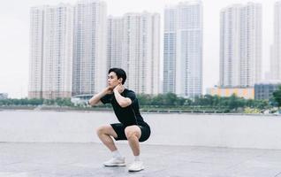 Young Asian man exercising in park photo