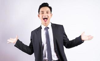 Image of young Asian businessman wearing suit on white background photo