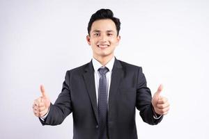 Image of young Asian businessman wearing suit on white background photo