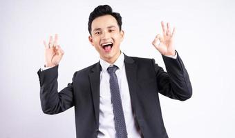 Image of young Asian businessman wearing suit on white background photo