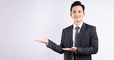 Image of young Asian businessman wearing suit on white background photo