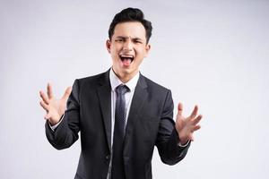 Image of young Asian businessman wearing suit on white background photo