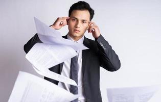 Stressed Asian businessman on white background photo