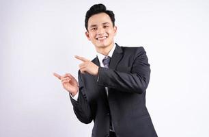 Image of young Asian businessman wearing suit on white background photo