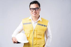 Image of Asian engineer with smiling on gray background photo