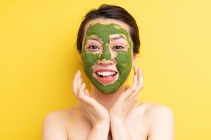 Young girl masked to exfoliate, beautify herself photo