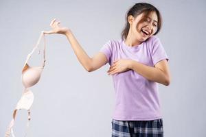 The young Asian girl took off her bra with a happy face photo