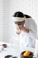 Portrait of a woman making facial mask doing spa procedures photo