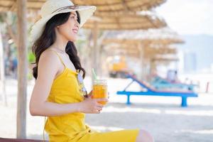 Young Asian woman enjoying summer vacation on the beach photo
