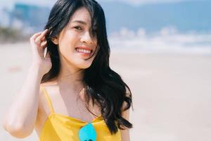 Young Asian woman enjoying summer vacation on the beach photo