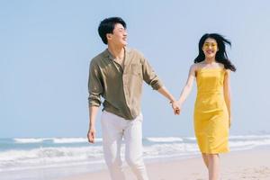 Young Asian couple enjoying summer vacation on the beach