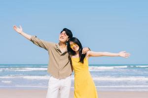 Young Asian couple enjoying summer vacation on the beach
