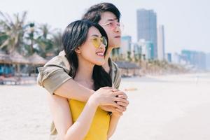 Young Asian couple enjoying summer vacation on the beach photo