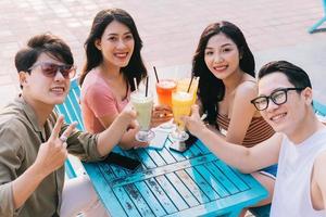 A group of young Asians enjoy a trip to the sea on a summer vacation photo