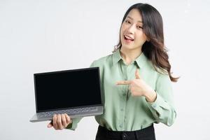 Portrait of a beautiful Asian businesswoman pointing her finger at the laptop screen photo