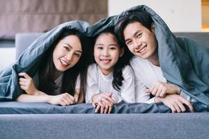 Happy Asian family portrait with mother, father and daughter photo